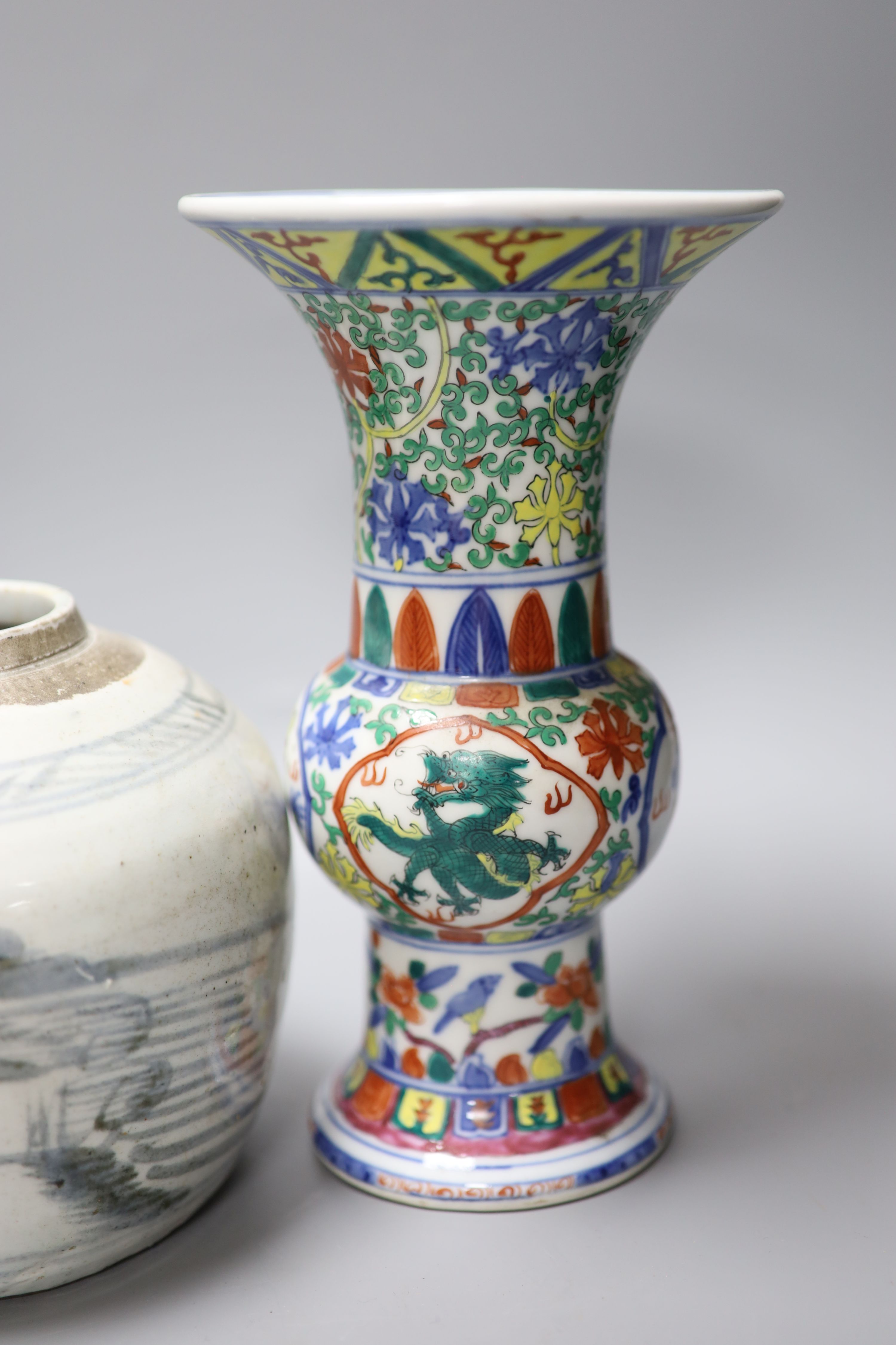 A pair of Chinese famille verte vases, height 24cm, and a jar